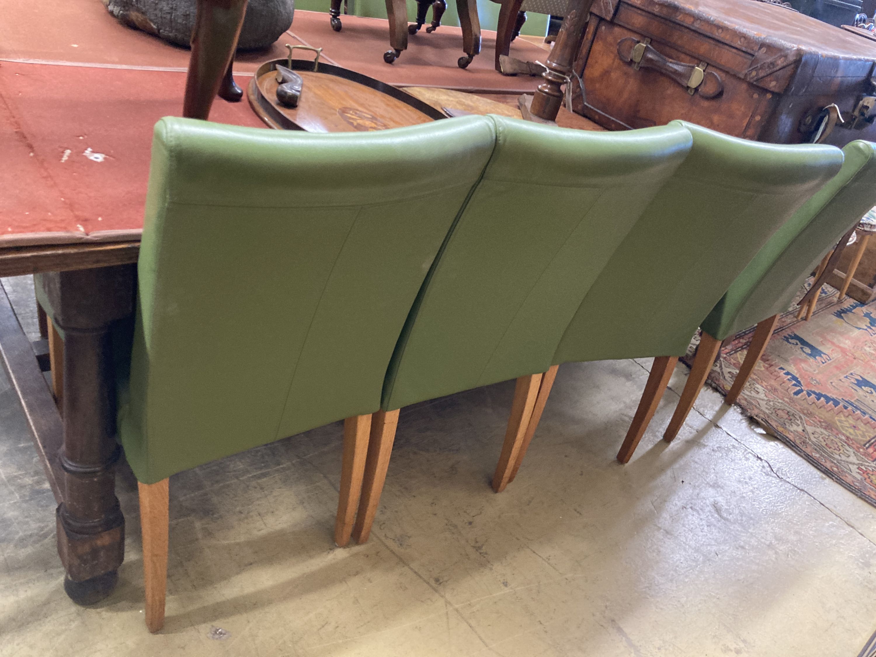 A set of eight contemporary oak and green leather dining chairs, width 45cm, depth 50cm, height 95cm